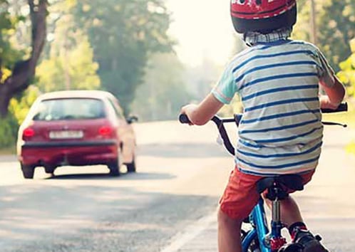 kid riding bike in street