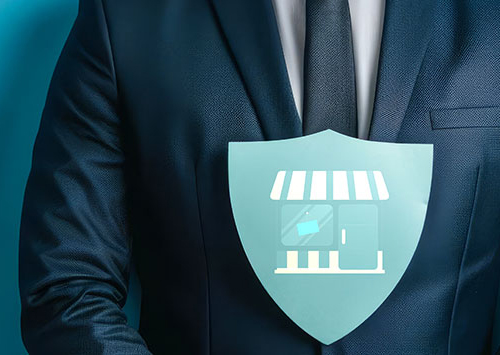 Illustration of storefront on shield in front of business man in suit.