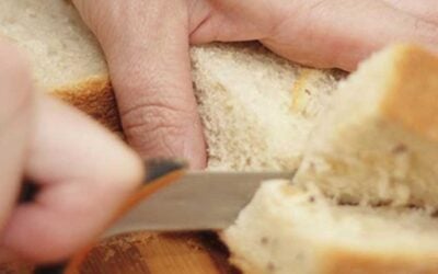 slicing white bread with a knife