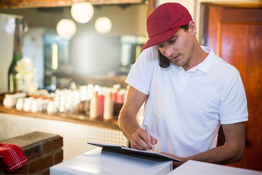 Big Game Weekend: 4 tips delivery drivers should know: Image of a quick delivery restaurant taking an order over the phone.