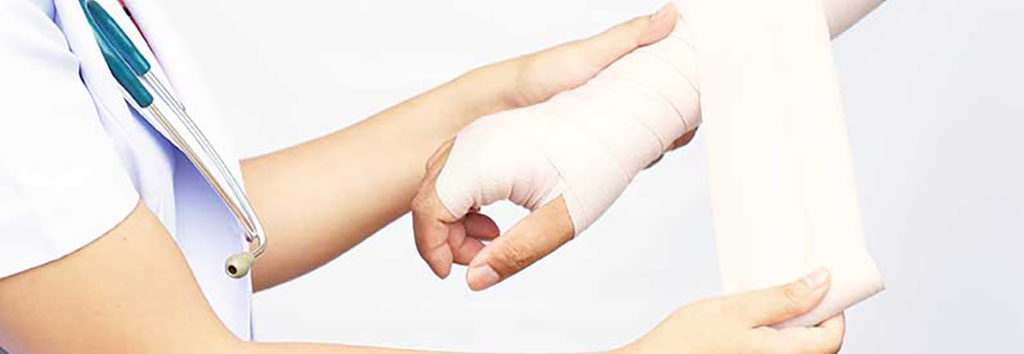 medical professional wrapping a patient's wrist with an ace bandage