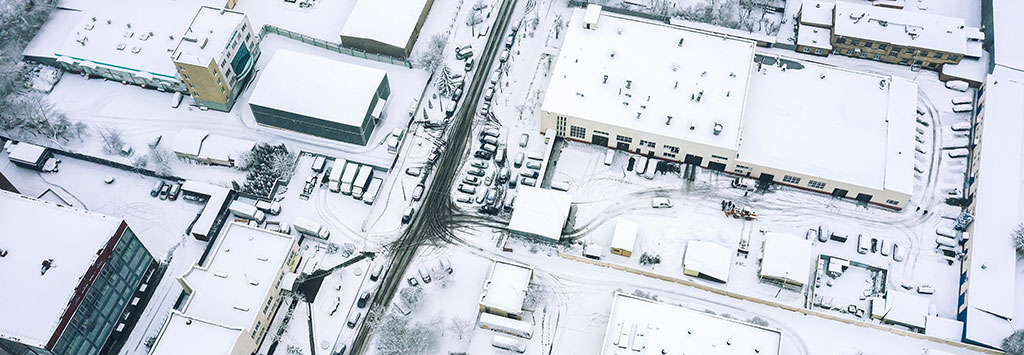 Aerial view of snow covered businesses in winter.