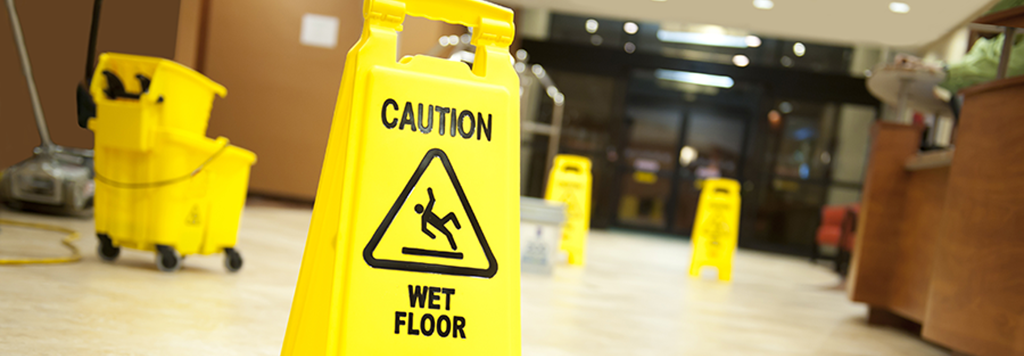 Mopped floor with Caution Wet floor signs