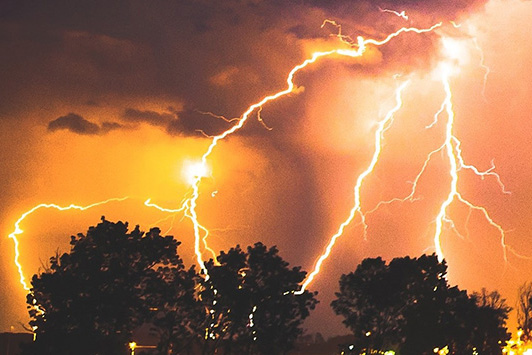 Image of a storm with lightning bolting to the ground.