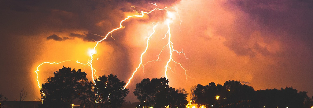 Image of a storm with lightning bolting to the ground.