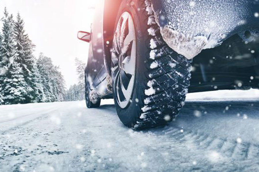 Are you Shop Ready for Winter: View of snowy road from behind car tire.
