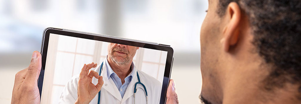 Man talking to doctor via tablet