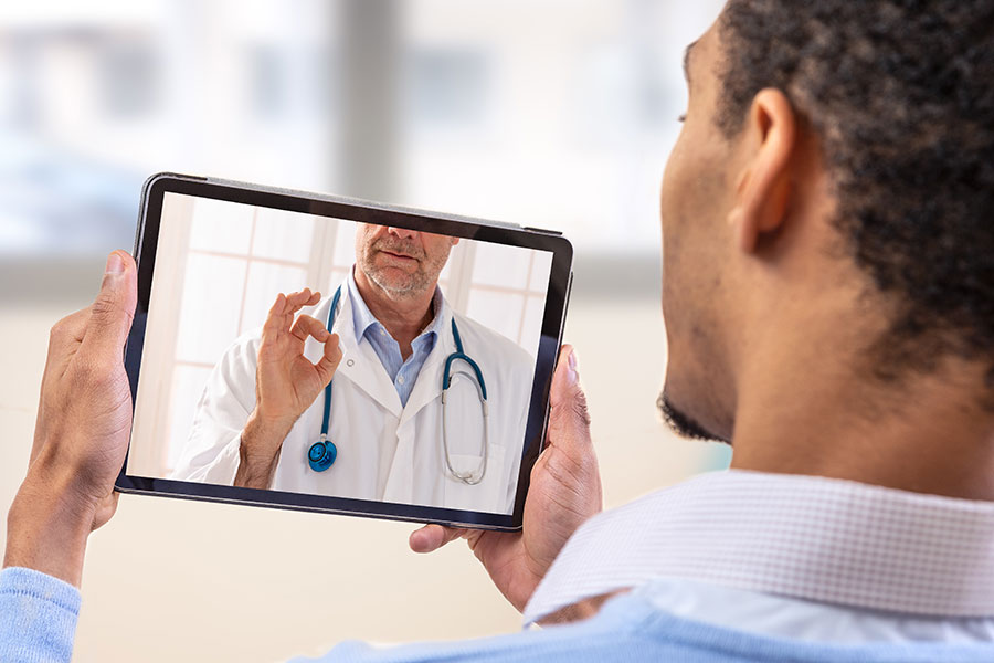 Man speaking to a doctor on his tablet device.